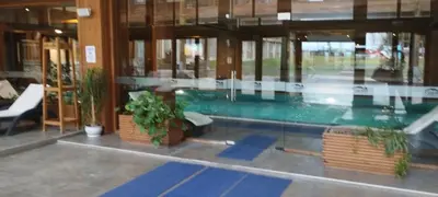 a swimming pool in a building with plants at PIRIN GOLF - NIRVANA new, SPA in Razlog