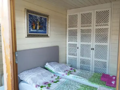 a small room with a bed and a picture at PIRIN GOLF - NIRVANA new, SPA in Razlog