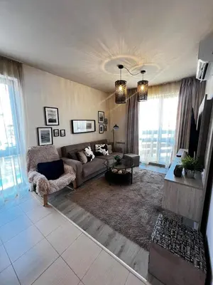 a living room with a couch and a table at BANSKO Deluxe Apartment Belvedere - 350m SkiLift in Bansko