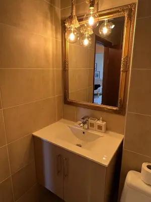 a bathroom with a sink and a mirror at BANSKO Deluxe Apartment Belvedere - 350m SkiLift in Bansko