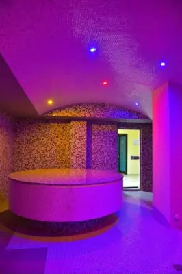 a purple room with a round table in the middle at BANSKO Deluxe Apartment Belvedere - 350m SkiLift in Bansko