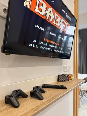 a tv with two video game controllers on a table at Luxury & Comfort near the University in Blagoevgrad