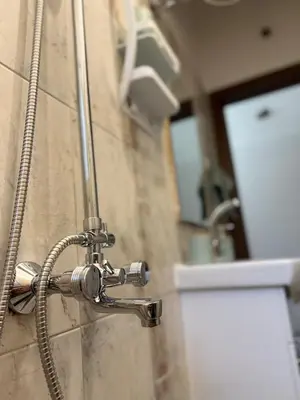 a shower in a bathroom with a shower head at Center Chill ARTpartment in Sofia