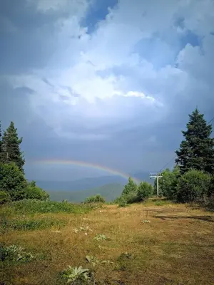 a view of a field with a rainbow in the sky at Малка Къщичка Бяла Черква