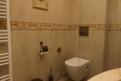 a bathroom with a toilet and a sink at Апартамент за гости Марица in Asenovgrad