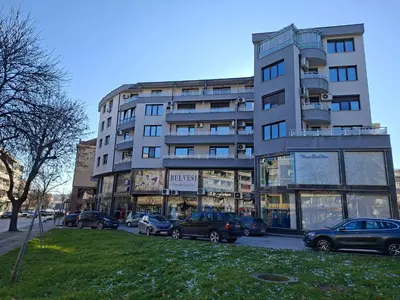 a tall building with cars parked in front of it at Апартамент за гости Марица in Asenovgrad