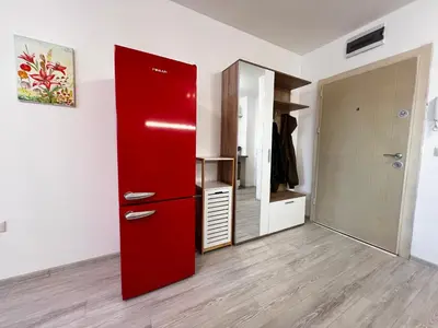 a red refrigerator in a room with a closet at Warsaw Cozy Studio near UNSS and NSA with Balcony in Sofia