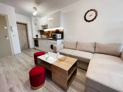 a living room with a couch and a table at Warsaw Cozy Studio near UNSS and NSA with Balcony in Sofia
