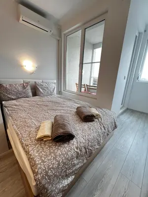 a bedroom with a bed with two pillows on it at Warsaw Cozy Studio near UNSS and NSA with Balcony in Sofia