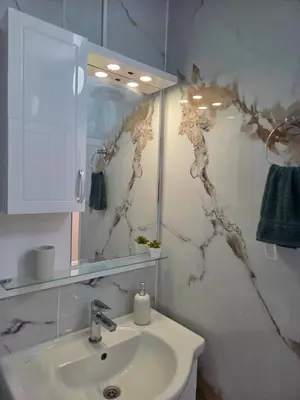 a bathroom with a sink and a mirror at Apartment Lily Complex Padaloto in Smolyan