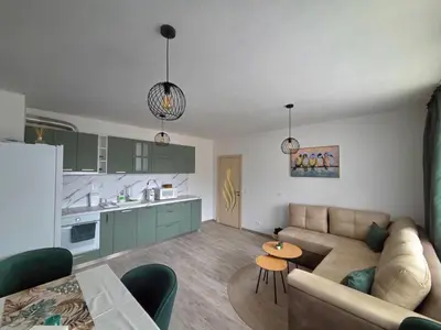 a living room with a couch and a kitchen at Apartment Lily Complex Padaloto in Smolyan