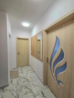 a hallway with a door and a tile floor at Apartment Lily Complex Padaloto in Smolyan