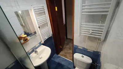 a bathroom with a toilet and a sink and a mirror at Apartment Danik City Garden in Bansko