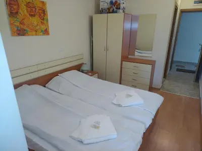a bedroom with two beds with towels on them at Sunny Studio Eagle Rock in Beli Iskar