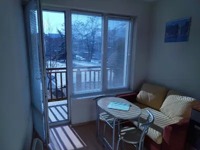 a small living room with a table and a couch at Sunny Studio Eagle Rock in Beli Iskar