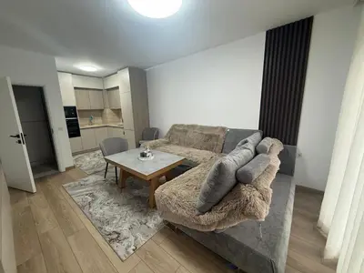 a living room with a couch and a table at River side apartment in Sandanski