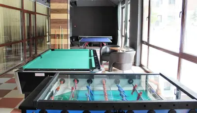 a pool table in the middle of a room at Private studio B27 in Borovets Gardens in Borovets