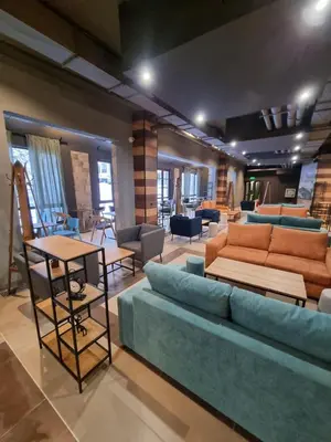 a living room with a blue couch and chairs at Private studio B27 in Borovets Gardens in Borovets
