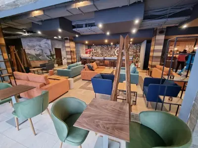 a room with tables and chairs and a bar at Private studio B27 in Borovets Gardens in Borovets