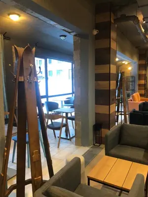 a living room with a group of chairs and skis at Private studio B27 in Borovets Gardens in Borovets
