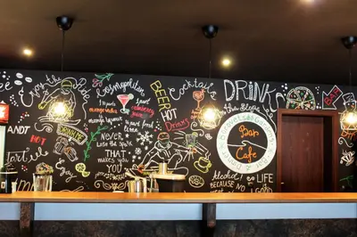 a wall covered in graffiti in a restaurant at Private studio B27 in Borovets Gardens in Borovets