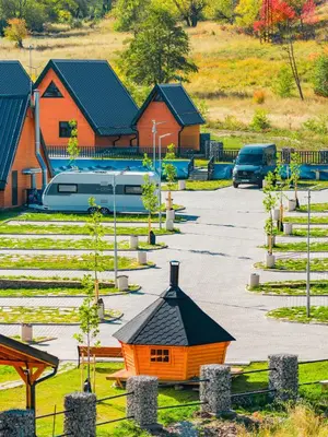 an orange building in a parking lot with houses at Caravan for rent in Bansko