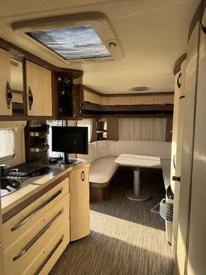 a small kitchen with a table and a tv in it at Caravan for rent in Bansko