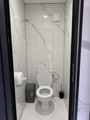 a bathroom with a white toilet in a room at Caravan for rent in Bansko