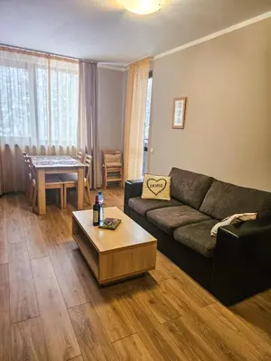 a living room with a couch and a table at Vista Apartment in Borovets
