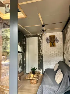 a living room with a couch and a table at The Cube in Samokov
