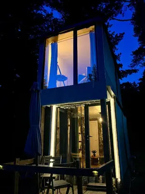 a house with a large window and a table and chairs at The Cube in Samokov