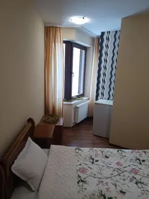 a small room with a bed and a window at Студио Студенец in Pamporovo