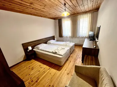 a bedroom with a bed and a couch in a room at Къща за гости в село Проглед - комплекс Божидарица 4А in Progled