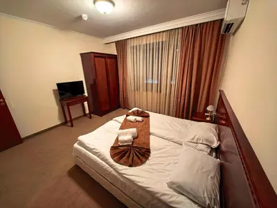 a hotel room with a bed with a bag on it at Mountain Heaven Downtown in Bansko