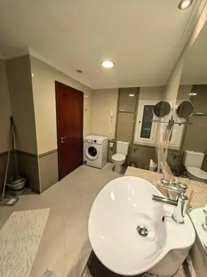 a bathroom with a sink and a washing machine at Mountain Heaven Downtown in Bansko