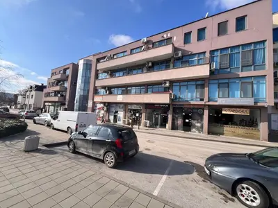 a car parked in a parking lot in front of a building at Апартамент Аксел in Panagyurishte