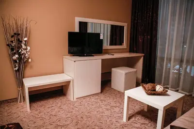 a living room with a desk with a television on it at Einstein House & Spa in Marchevo