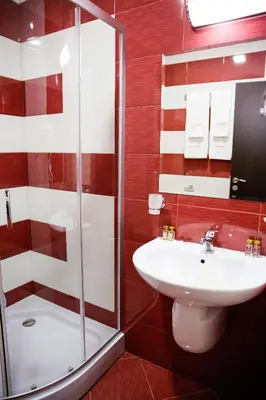 a bathroom with a toilet sink and a shower at Einstein House & Spa in Marchevo