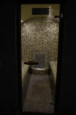 a dark room with a table and a bench at Einstein House & Spa in Marchevo