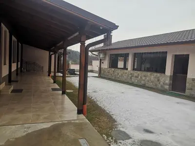 a covered walkway in front of a building at Алтъна Калофер in Kalofer