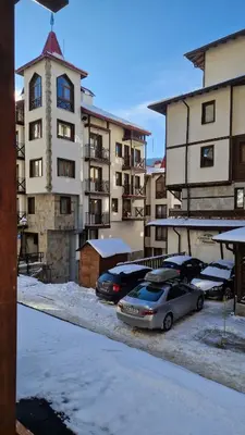 a group of cars parked in a parking lot in front of buildings at Studio Kalina Green Life in Pamporovo
