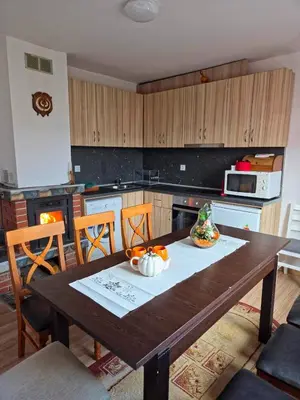 a kitchen with a wooden table with fruit on it at Guest house Belitsa in Semkovo