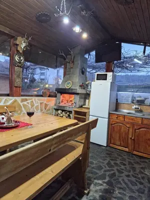 a kitchen with a white refrigerator and a stove at Guest house Belitsa in Semkovo