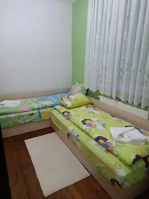 two twin beds in a room with a window at Марковата Къща in Madzhare