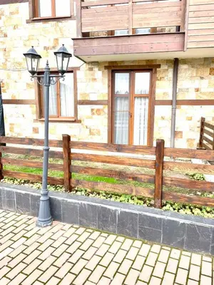 a street light in front of a wooden fence at The Mountain Hug 1BR by SI Stay in Bansko
