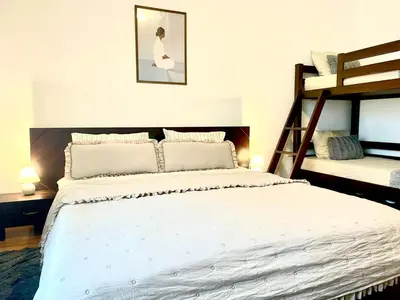 a bedroom with a bed and two bunk beds at The Mountain Hug 1BR by SI Stay in Bansko