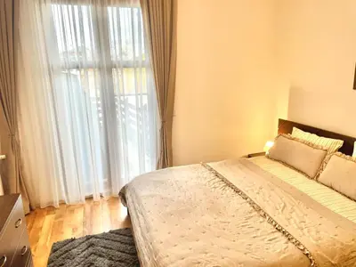 a bedroom with a bed and a large window at The Mountain Hug 1BR by SI Stay in Bansko