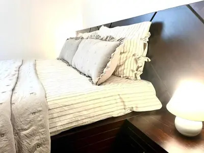 a bed with two pillows on it in a room at The Mountain Hug 1BR by SI Stay in Bansko