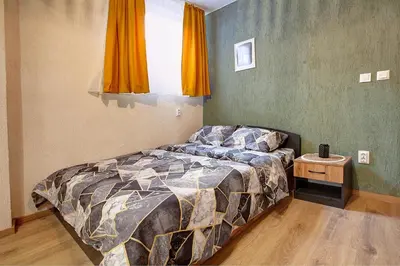 a bedroom with a bed and a window at Cozy Homes Slivnitsa Studios in Sofia