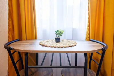 a table with a potted plant sitting on top of it at Cozy Homes Slivnitsa Studios in Sofia